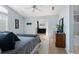 Bright main bedroom featuring a ceiling fan, a dresser, and carpet at 1355 S Ulster St, Denver, CO 80231