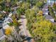 Aerial view of a quiet neighborhood street lined with mature trees and well-maintained homes at 1355 S Ulster St, Denver, CO 80231