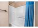 Bright bathroom featuring a clean white shower and a blue shower curtain at 11620 W 62Nd Pl # 201, Arvada, CO 80004