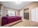 Cozy bedroom with a large window, plush carpeting, and ample storage with multiple closets at 11620 W 62Nd Pl # 201, Arvada, CO 80004