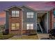 Charming condo with red brick and light-gray siding at sunset at 11620 W 62Nd Pl # 201, Arvada, CO 80004