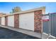Row of detached garages constructed with brick and white doors in community at 11620 W 62Nd Pl # 201, Arvada, CO 80004