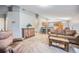Spacious living room with bar seating and open-concept layout leading to the kitchen and dining area at 11620 W 62Nd Pl # 201, Arvada, CO 80004