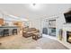 Comfortable living room with sliding glass door and fireplace, showcasing the kitchen and dining area at 11620 W 62Nd Pl # 201, Arvada, CO 80004