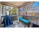 Cozy covered patio furnished with a wicker sofa and a decorative outdoor rug at 11620 W 62Nd Pl # 201, Arvada, CO 80004