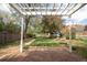 Backyard boasts a pergola, stone patio, gravel path, and lush lawn at 539 Baker St, Longmont, CO 80501