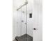 This modern bathroom features a glass shower with sleek subway tile and dark, honeycomb floor at 539 Baker St, Longmont, CO 80501