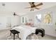 A bright bedroom with luxury bedding and a ceiling fan at 539 Baker St, Longmont, CO 80501