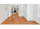 Bright bedroom boasts hardwood floors and flows into kitchen through an arched doorway at 539 Baker St, Longmont, CO 80501