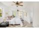 A bright bedroom with luxury bedding and a ceiling fan at 539 Baker St, Longmont, CO 80501