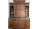 Elaborate dark wood cabinetry with stone counters and display shelves at 539 Baker St, Longmont, CO 80501
