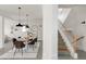 A dining room with hardwood floors, a table, and stairs leading to the upper level at 539 Baker St, Longmont, CO 80501