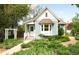 Charming home with light blue siding, well-manicured landscaping, and a welcoming front porch at 539 Baker St, Longmont, CO 80501