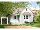 Charming home with light blue siding, manicured landscaping, and a covered front porch at 539 Baker St, Longmont, CO 80501