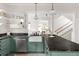 Stylish kitchen with green cabinetry, granite countertops, and stainless steel appliances at 539 Baker St, Longmont, CO 80501