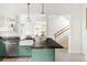 Modern kitchen with green cabinets, granite countertops, and stainless steel appliances and fixtures at 539 Baker St, Longmont, CO 80501
