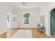 Bright living room with hardwood floors, white walls, and large windows overlooking greenery at 539 Baker St, Longmont, CO 80501