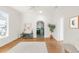 Inviting living area with hardwood floors, neutral decor, and arched doorway to the kitchen at 539 Baker St, Longmont, CO 80501