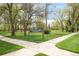 Green lawn at Collyer Park with walking paths and trees on a sunny day at 539 Baker St, Longmont, CO 80501