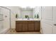 Bathroom featuring a dual sink vanity, large mirror, updated fixtures, and a glass-enclosed shower at 1107 Sunrise Dr, Brighton, CO 80603