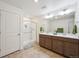 Bathroom with double sink vanity, a glass-enclosed shower, and updated fixtures at 1107 Sunrise Dr, Brighton, CO 80603