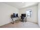 Carpeted office space with two computer desks and a window for natural light at 1107 Sunrise Dr, Brighton, CO 80603