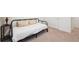 Bedroom featuring a black metal frame bed with a white comforter and two cream pillows at 1107 Sunrise Dr, Brighton, CO 80603