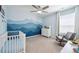 Baby's room with unique wall art and grey rocking chair at 1107 Sunrise Dr, Brighton, CO 80603