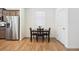 Bright dining area with a dark wood table and seating for four next to the kitchen at 1107 Sunrise Dr, Brighton, CO 80603