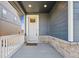 Cozy front porch with stone accents and a white railing at 1107 Sunrise Dr, Brighton, CO 80603