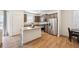 Well-lit kitchen features stainless steel appliances, a center island, and wood-look floors at 1107 Sunrise Dr, Brighton, CO 80603