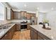 Modern kitchen with stainless steel appliances, granite countertops, and wood floors at 1107 Sunrise Dr, Brighton, CO 80603
