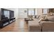 Comfortable living room features a large sectional sofa, wood floors, and natural light at 1107 Sunrise Dr, Brighton, CO 80603