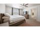 Spacious main bedroom featuring a ceiling fan and an en-suite bathroom at 1107 Sunrise Dr, Brighton, CO 80603