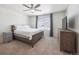 Serene main bedroom with a ceiling fan, neutral walls, and a large window at 1107 Sunrise Dr, Brighton, CO 80603