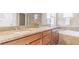 Bathroom featuring a granite countertop, dual sinks and a soaking tub with jets at 404 Dusk Ct, Erie, CO 80516