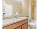 Bathroom features a granite countertop, warm neutral colors and a shower over the tub at 404 Dusk Ct, Erie, CO 80516