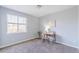 Neutral bedroom featuring plush carpeting, desk, chair and natural light from a large window at 404 Dusk Ct, Erie, CO 80516