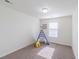 A bright bedroom featuring a teepee and yellow stool; minimalist decor with plenty of natural light at 404 Dusk Ct, Erie, CO 80516