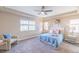 Bright bedroom with blue accents, plush carpeting and large window with natural light at 404 Dusk Ct, Erie, CO 80516
