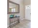 Bright entryway with decorative table and mirror, enhanced by light wood flooring at 404 Dusk Ct, Erie, CO 80516