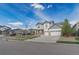 Attractive two-story home featuring a three-car garage and well-manicured front yard at 404 Dusk Ct, Erie, CO 80516