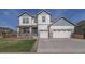 Charming two-story house with a welcoming front porch and a spacious three-car garage at 404 Dusk Ct, Erie, CO 80516