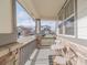 Cozy covered front porch with stone accents, offering a relaxing outdoor seating area at 404 Dusk Ct, Erie, CO 80516