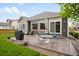 The backyard features a patio with outdoor seating, a grill, and well-maintained lawn at 17247 E 103Rd Ave, Commerce City, CO 80022