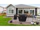 Backyard with a patio, grill, and manicured lawn, perfect for outdoor entertaining at 17247 E 103Rd Ave, Commerce City, CO 80022