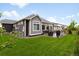 Manicured backyard with a patio, lush green lawn, and beautiful landscaping at 17247 E 103Rd Ave, Commerce City, CO 80022