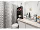The bathroom is equipped with a shower over a toilet, a sink with a vanity, and plenty of storage space at 17247 E 103Rd Ave, Commerce City, CO 80022