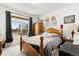 Cozy bedroom with a large window that offers a lovely view of the neighborhood at 17247 E 103Rd Ave, Commerce City, CO 80022
