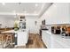 Beautiful kitchen featuring white cabinets, stainless appliances, a center island with seating, and a tiled backsplash at 17247 E 103Rd Ave, Commerce City, CO 80022